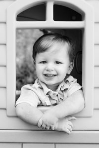 A child looking outside a playhouse.